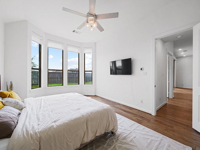 bedroom featuring ceiling fan and dark hardwood / wood-style floors