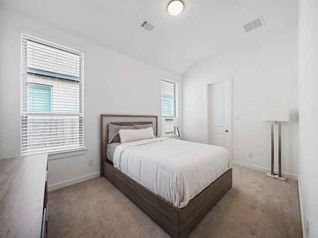 carpeted bedroom with lofted ceiling