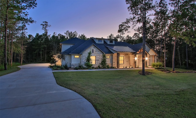 view of front of property with a garage and a yard