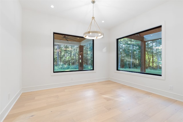 unfurnished room featuring ceiling fan and light wood-type flooring