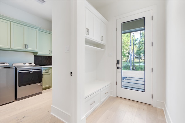 mudroom featuring washer and dryer and light wood-type flooring