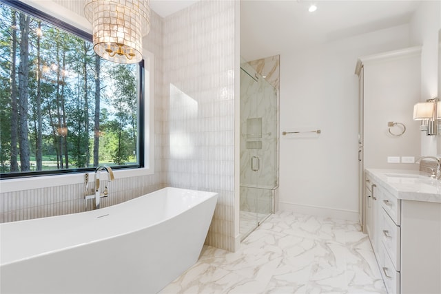 bathroom featuring vanity, shower with separate bathtub, a chandelier, and tile walls