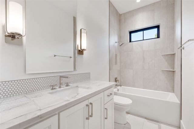 full bathroom featuring decorative backsplash, vanity, tiled shower / bath combo, and toilet