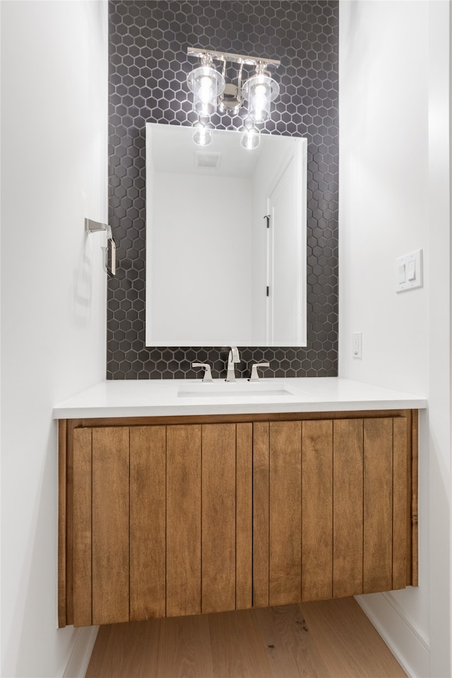 bathroom with hardwood / wood-style floors and vanity