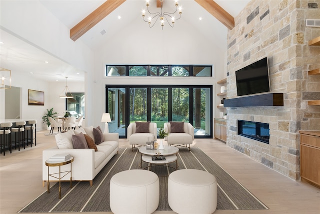 living room with a fireplace, beamed ceiling, and high vaulted ceiling