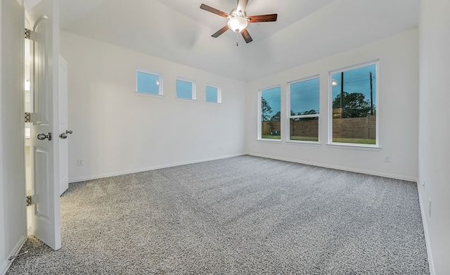 carpeted spare room with ceiling fan