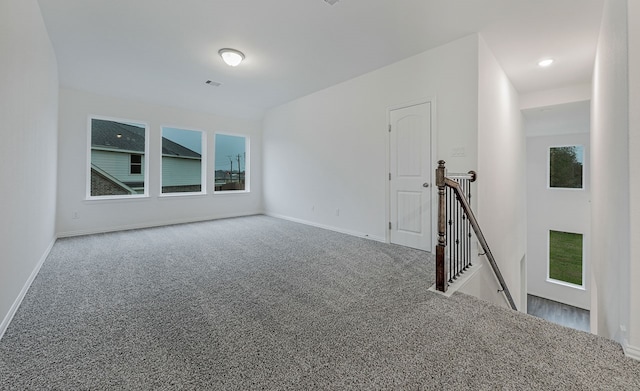 carpeted empty room with a healthy amount of sunlight