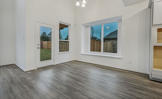 interior space with dark hardwood / wood-style floors and a notable chandelier