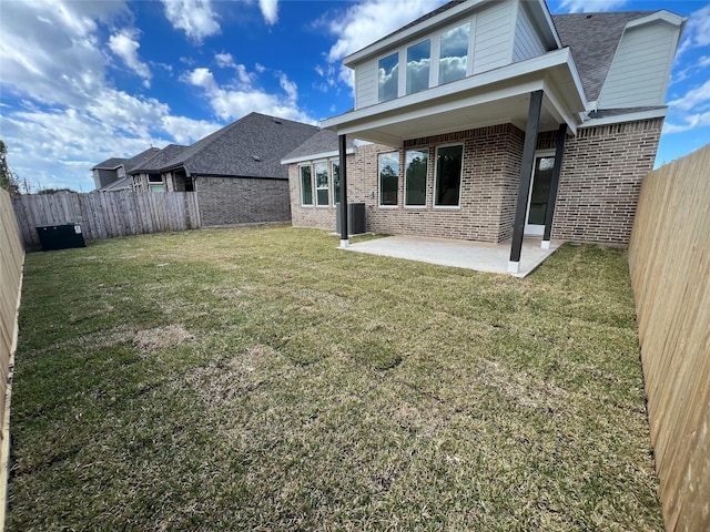 rear view of house with a patio area and a lawn