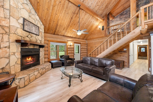 living room with wood finished floors, high vaulted ceiling, a fireplace, stairs, and wood ceiling