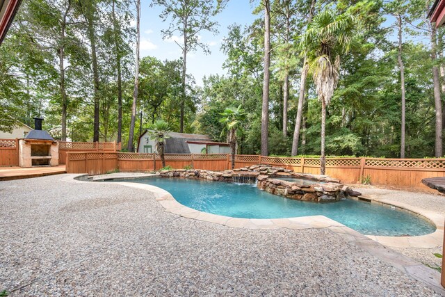 view of pool featuring an in ground hot tub, a patio, and an outdoor fireplace