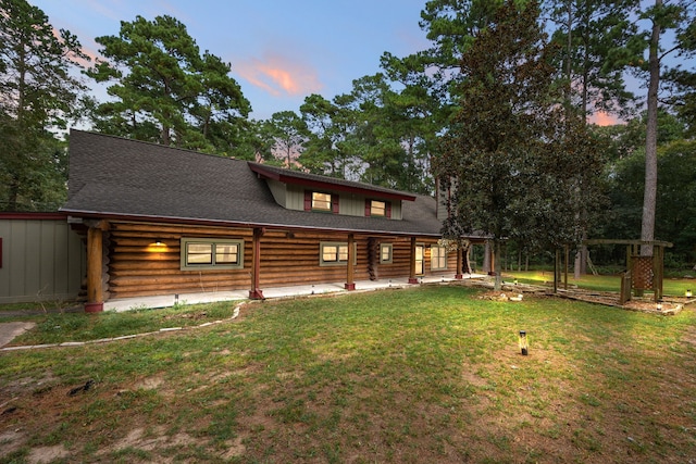 back house at dusk with a yard