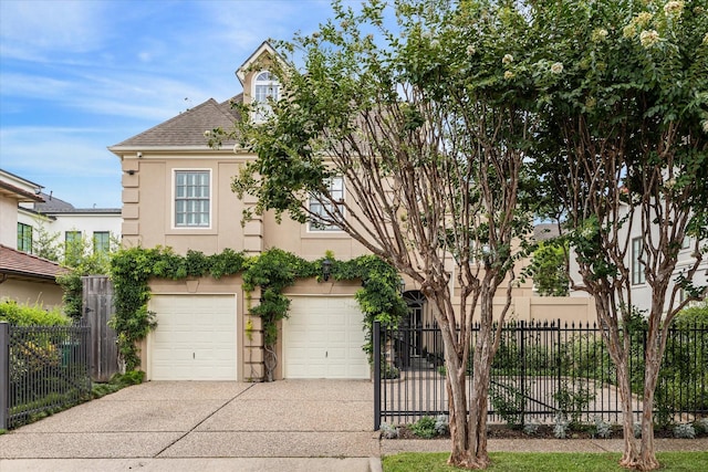 2509 Westgate Dr, Houston, TX 77019 - view of property hidden behind natural elements with stucco siding, driveway, an attached garage, and a shingled roof