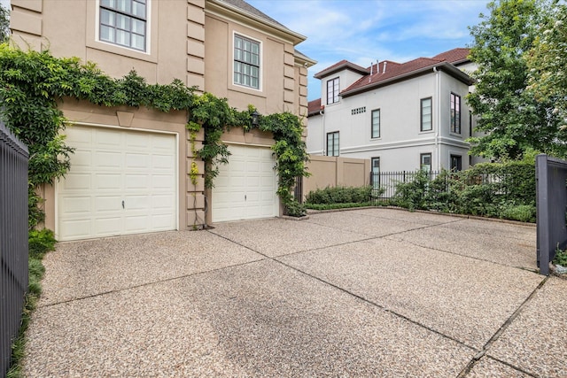 2509 Westgate Dr, Houston, TX 77019 - view of side of property featuring driveway, stucco siding, and an attached garage