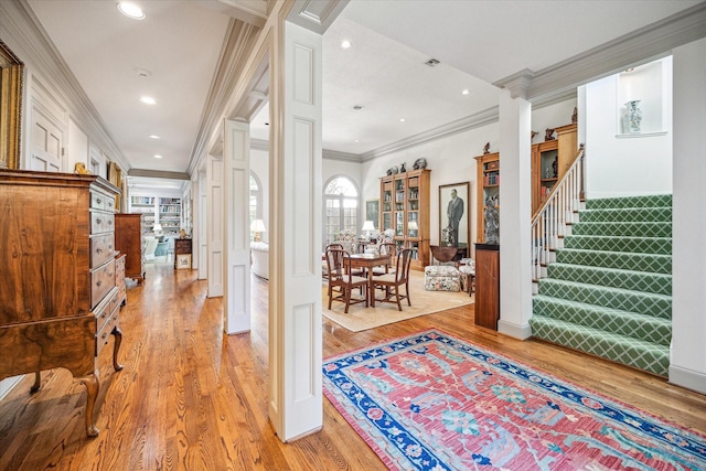 2509 Westgate Dr, Houston, TX 77019 - hall with crown molding, light wood finished floors, stairs, recessed lighting, and decorative columns