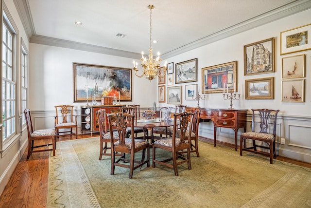 2509 Westgate Dr, Houston, TX 77019 - dining space featuring crown molding, a chandelier, wood finished floors, wainscoting, and recessed lighting