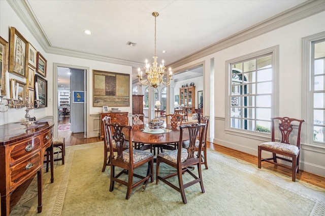 2509 Westgate Dr, Houston, TX 77019 - dining room with crown molding, a chandelier, and light wood-style flooring