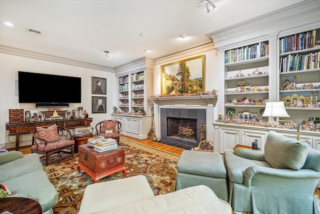 2509 Westgate Dr, Houston, TX 77019 - living room featuring a fireplace, crown molding, wood finished floors, and built in shelves