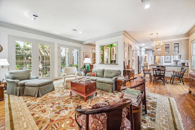 2509 Westgate Dr, Houston, TX 77019 - living area with a chandelier, crown molding, wood finished floors, french doors, and recessed lighting