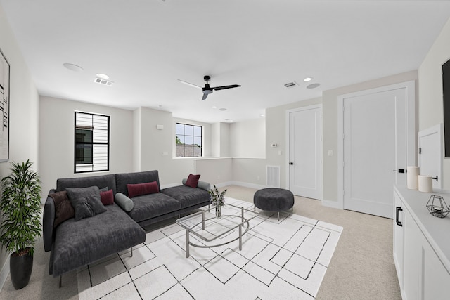 carpeted living room featuring ceiling fan