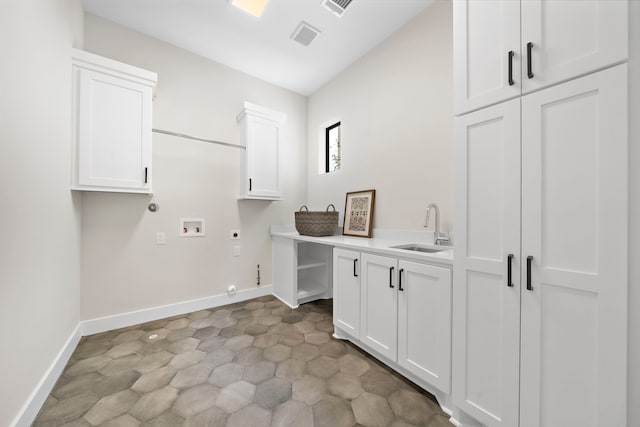 laundry area with gas dryer hookup, hookup for an electric dryer, sink, washer hookup, and cabinets