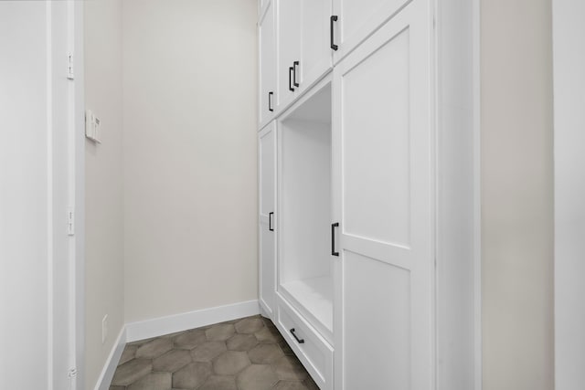 mudroom with dark tile patterned flooring