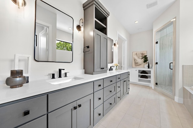 bathroom with vanity, walk in shower, and tile patterned flooring