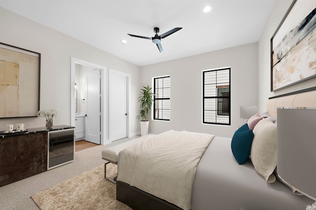 carpeted bedroom featuring ceiling fan, connected bathroom, and wine cooler