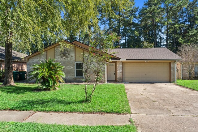 single story home featuring a front lawn and a garage