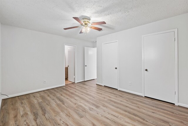 unfurnished bedroom featuring a textured ceiling, light hardwood / wood-style flooring, ceiling fan, and ensuite bathroom