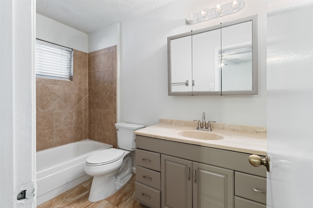 full bathroom with tiled shower / bath, vanity, toilet, and a textured ceiling