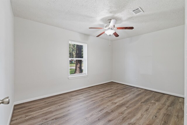 unfurnished room with a textured ceiling, ceiling fan, and hardwood / wood-style flooring