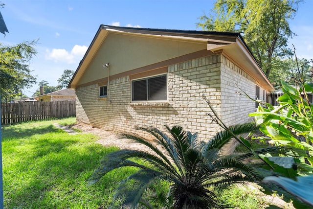 view of side of home featuring a yard