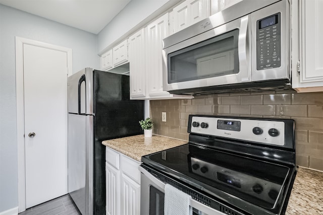 kitchen with white cabinets, backsplash, and appliances with stainless steel finishes