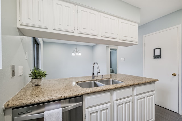 kitchen featuring pendant lighting, white cabinetry, an inviting chandelier, sink, and stainless steel dishwasher