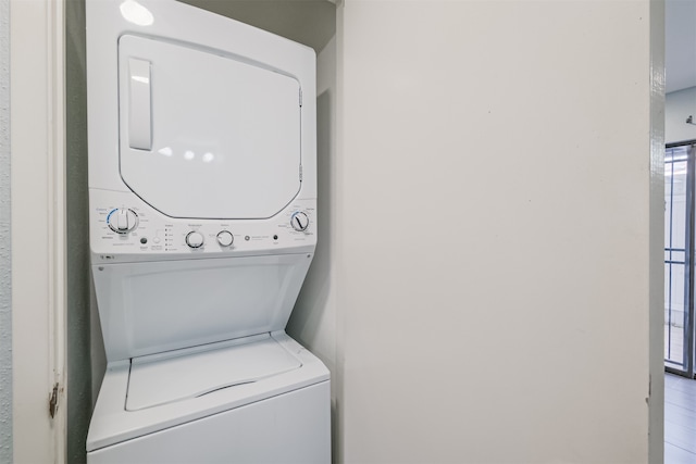 laundry area featuring stacked washer / drying machine