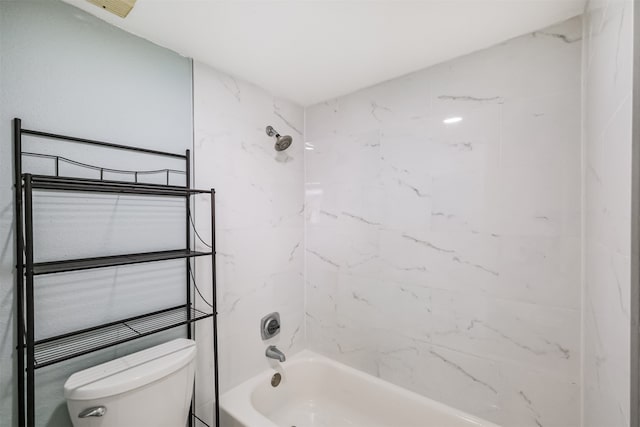 bathroom with tiled shower / bath combo and toilet