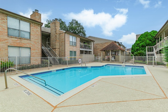 view of swimming pool with a gazebo and a patio area