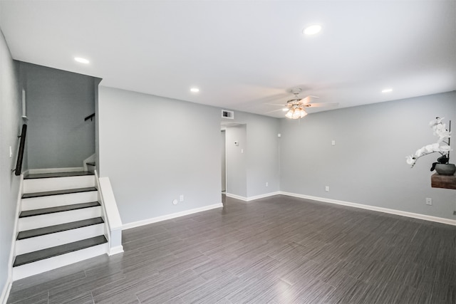 basement with ceiling fan and dark hardwood / wood-style floors