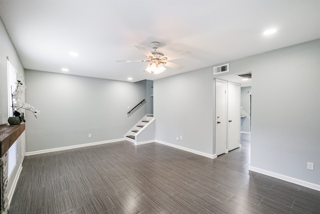 unfurnished living room featuring ceiling fan and dark hardwood / wood-style floors