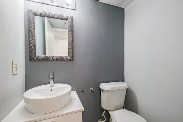 bathroom featuring toilet and vanity