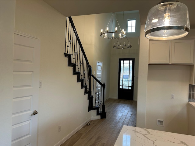 foyer featuring an inviting chandelier and dark wood-type flooring