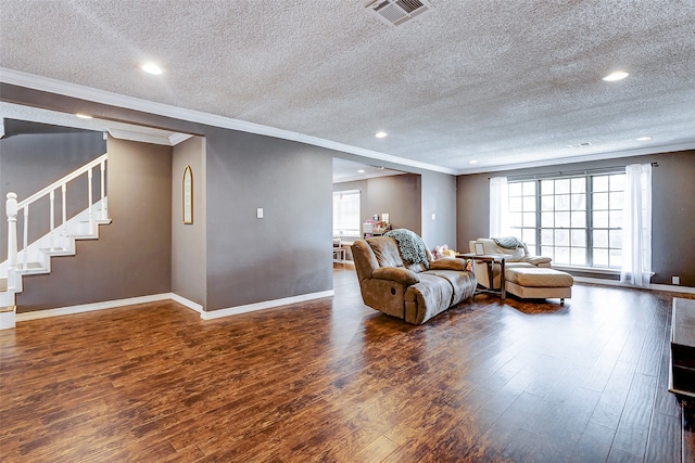 living room with crown molding, a textured ceiling, and dark hardwood / wood-style floors