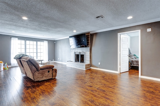 living room featuring a large fireplace, dark hardwood / wood-style floors, and crown molding