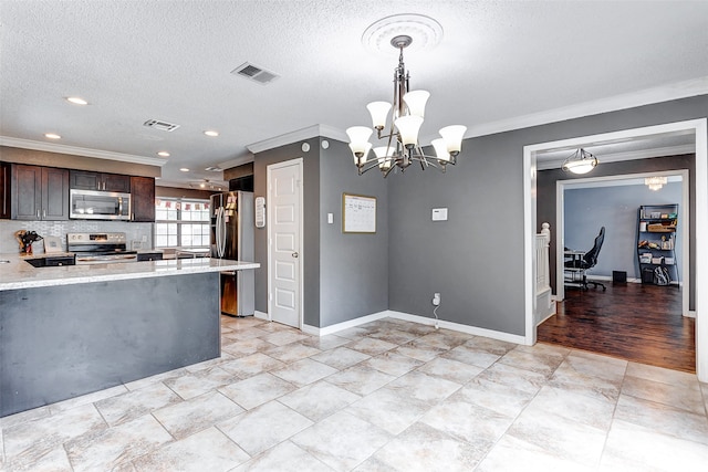 kitchen with appliances with stainless steel finishes, a textured ceiling, dark brown cabinets, and pendant lighting