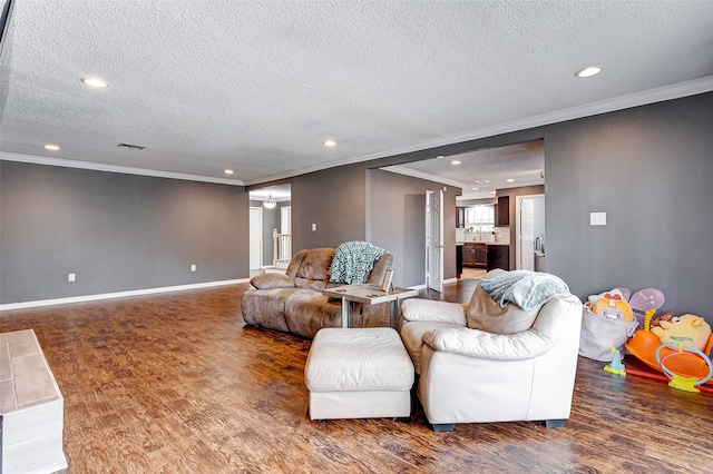 living room featuring ornamental molding, dark wood-type flooring, and a textured ceiling