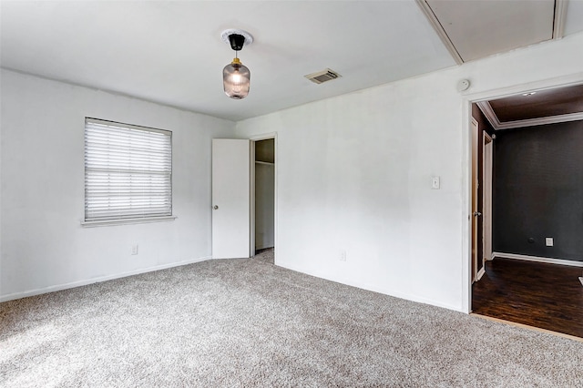 spare room featuring dark wood-type flooring and ornamental molding