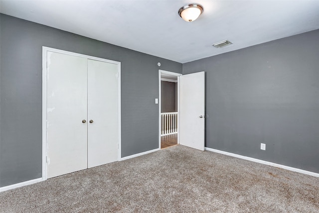 unfurnished bedroom with carpet and a closet