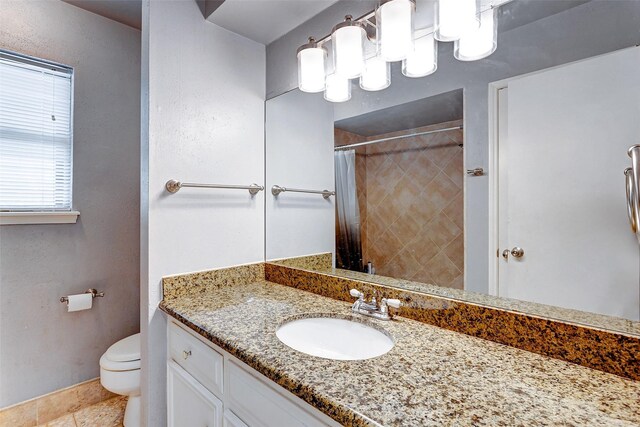 bathroom featuring curtained shower, tile patterned flooring, toilet, and vanity