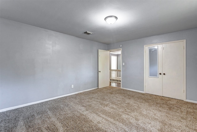 unfurnished bedroom featuring a closet and carpet